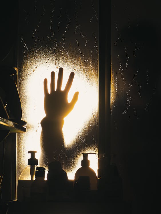 Free Silhouette of Human Hand on the Window Stock Photo