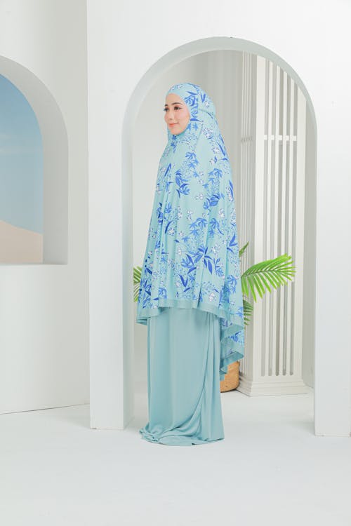 Beautiful Woman in Blue and White Hijab Standing Near White Wall