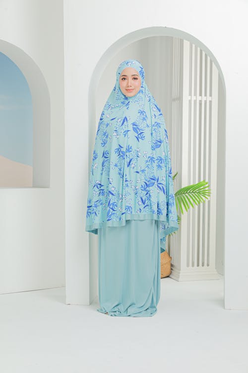 Beautiful Woman in Blue Hijab Standing Near White Wall