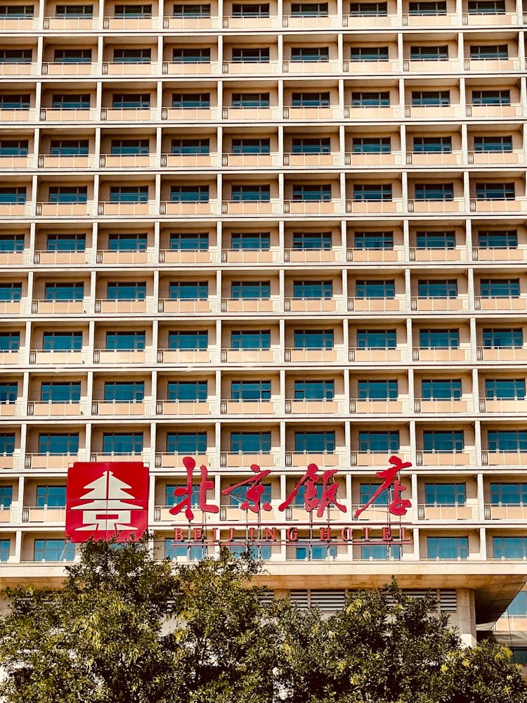 Brown Concrete Building With Red Signage