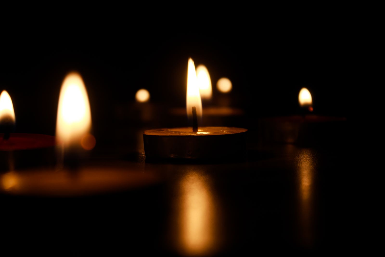 Handmade candles glowing warmly on display