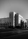 Grayscale Photo of a Building Near a Road