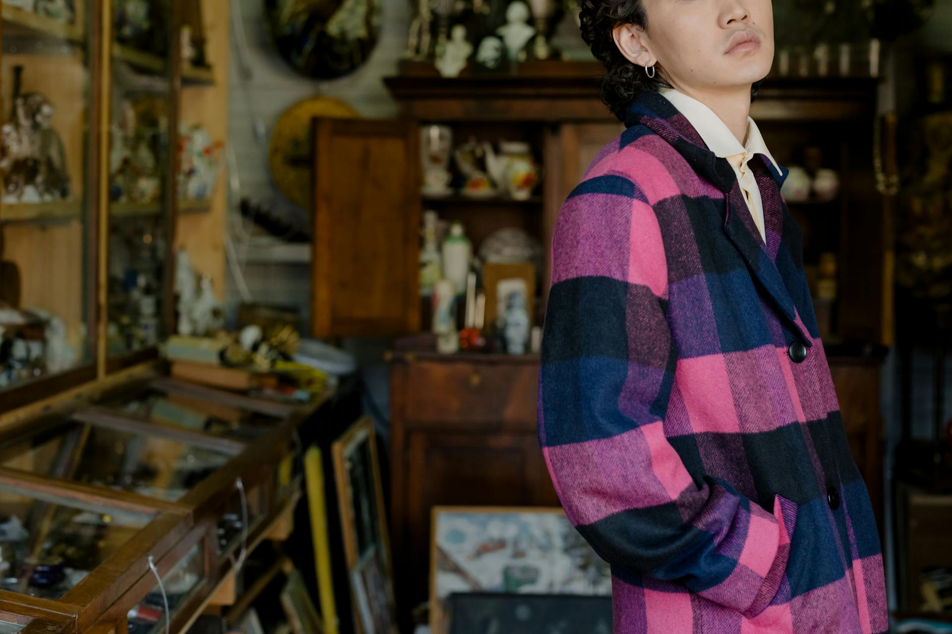 A Person Wearing a Multi Colored Plaid Coat in a Shop