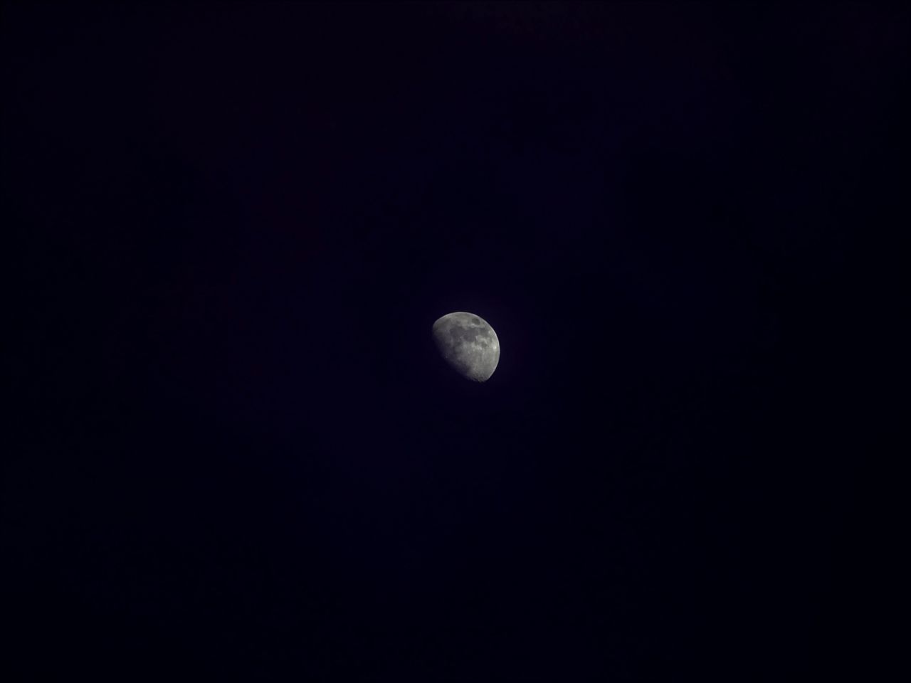 beautiful half moon captured against a dark night sky with ample copy