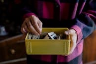Person holding a Yellow Box