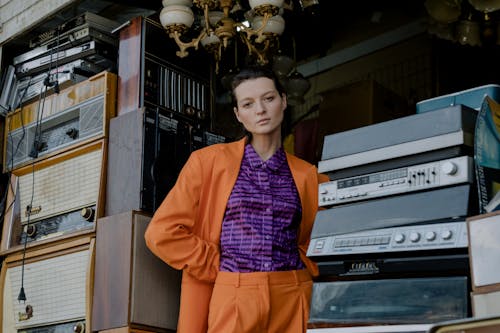 Woman Wearing Orange Suit in a Technology Shop 