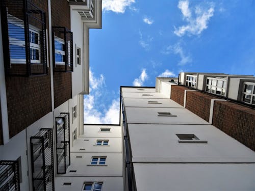Free Worms Eyeview Photography of White and Brown Buildings Stock Photo