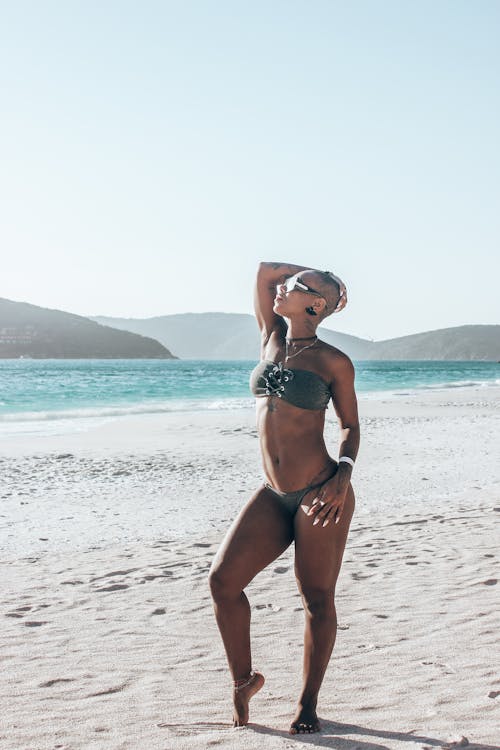 Woman in bikini posing on beach
