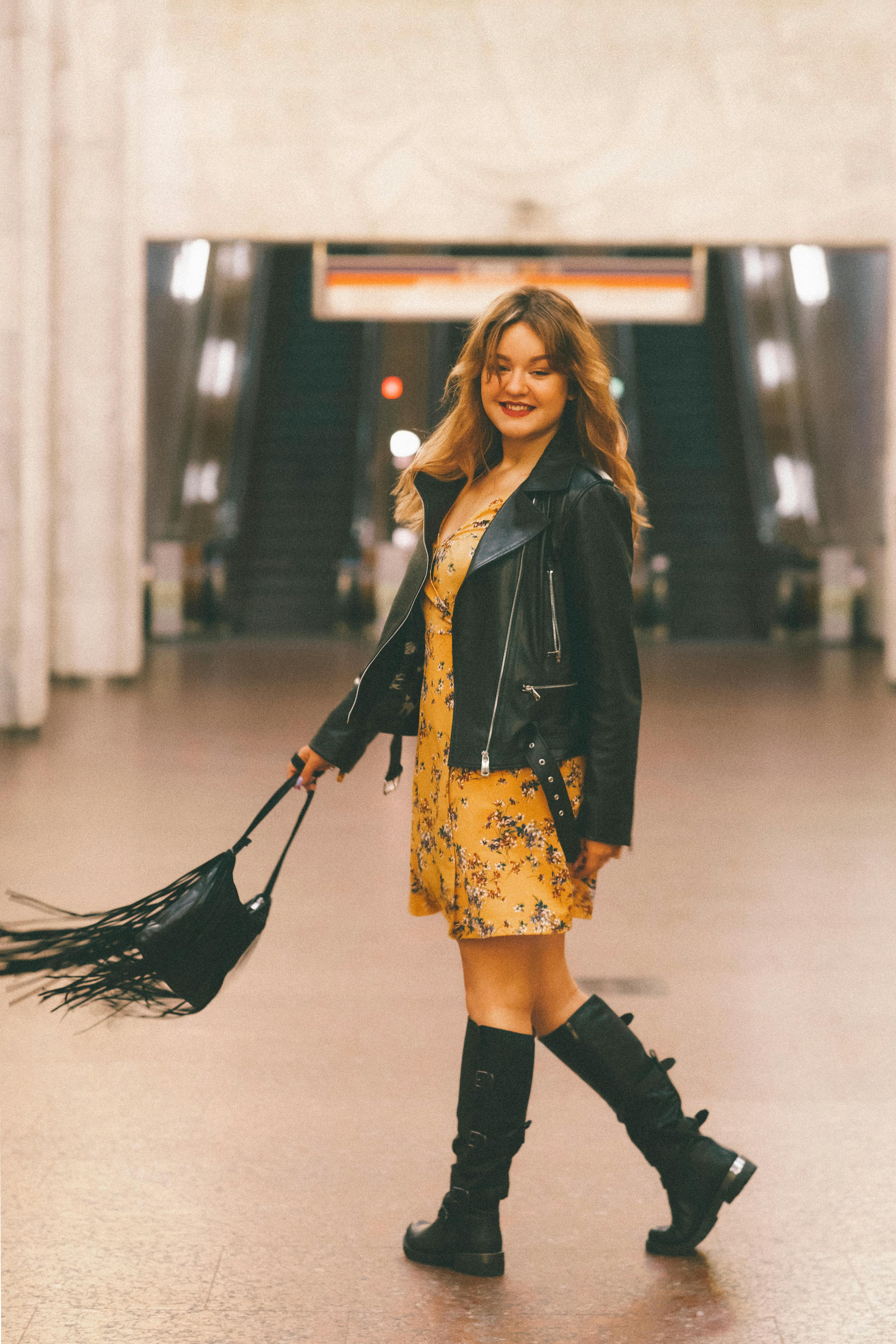 A Woman in Yellow Dress and Black Leather Jacket Dancing  Free Stock Photo