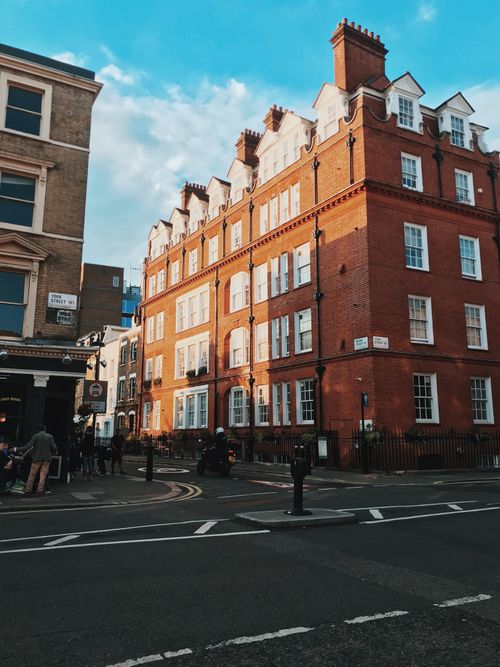Free Quaint red brick building on a London street corner with urban charm and historic architecture. Stock Photo