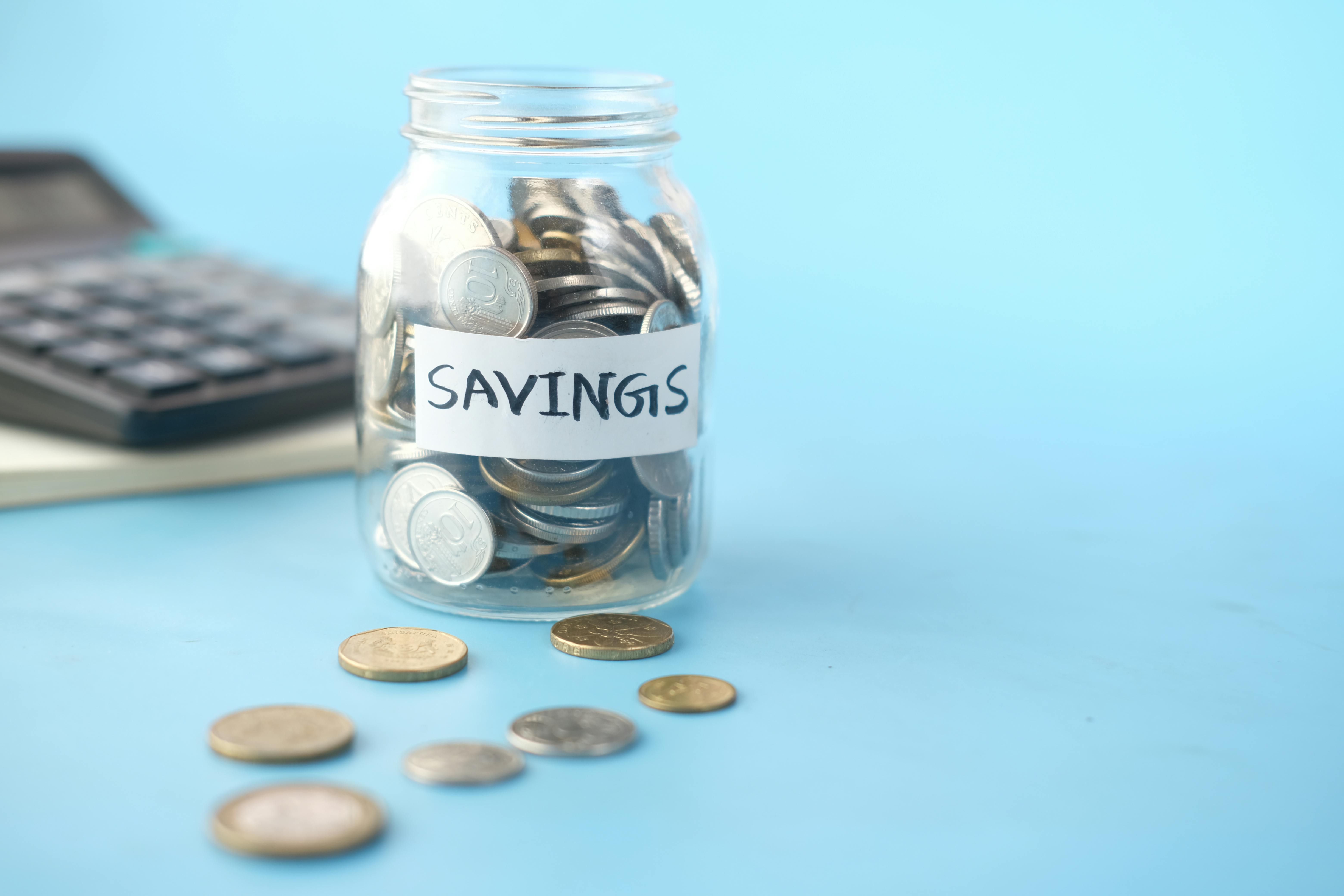 clear glass jar with silver coins