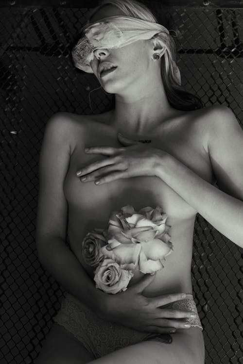 A Naked Woman Holding Flowers