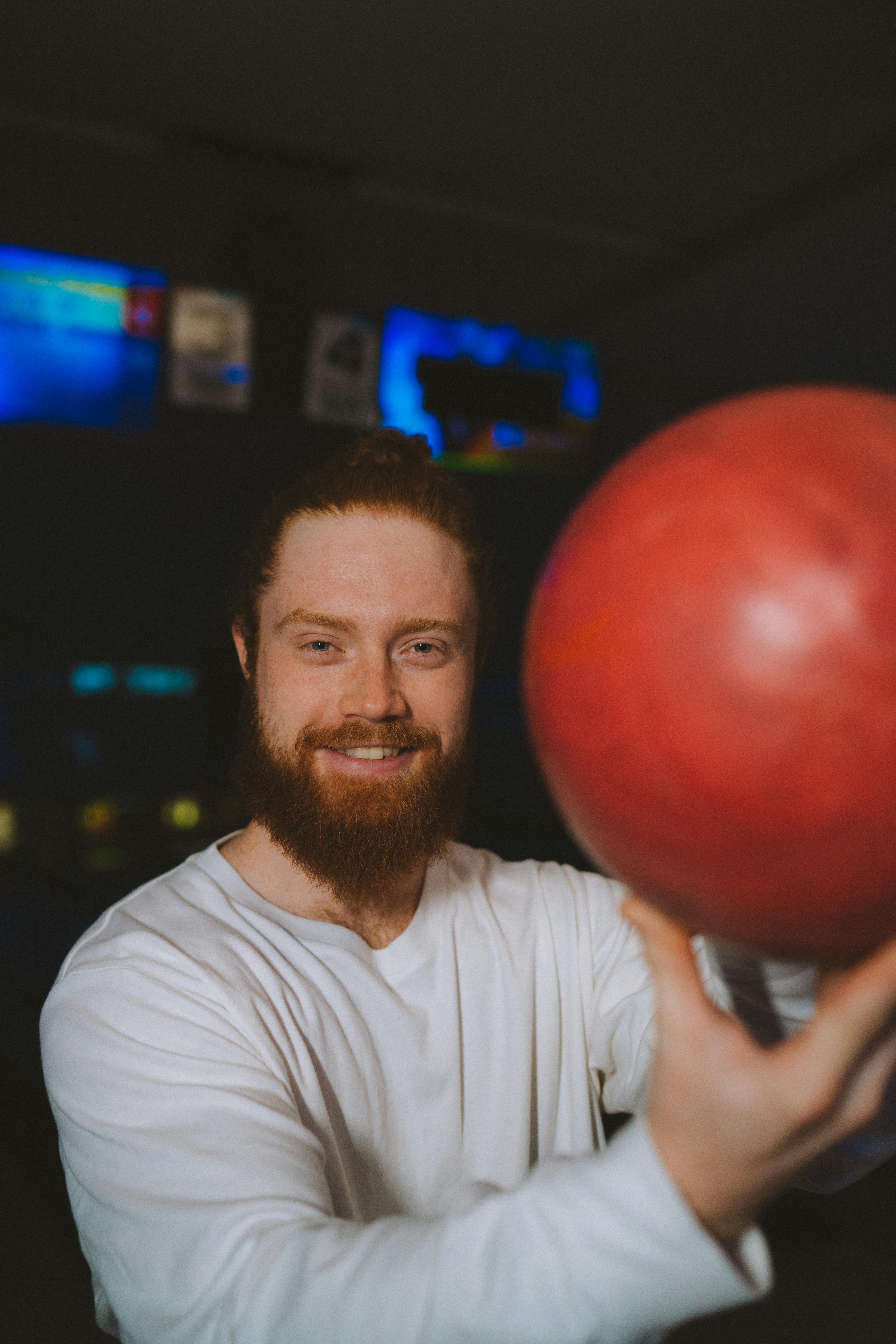 A Man Holding a Bowling Ball · Free Stock Photo