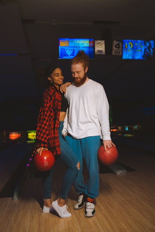 Free Man and Woman Holding Bowling Balls Stock Photo