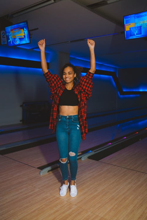 A Woman Standing while Raising Her Arms