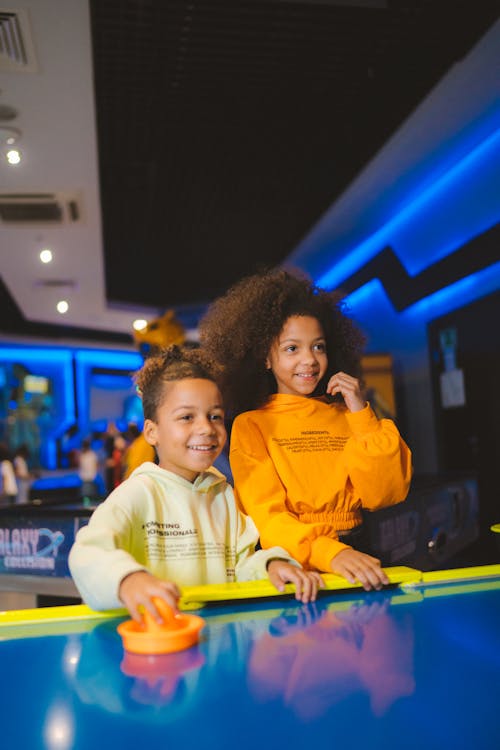 Two Kids Playing Air Hockey