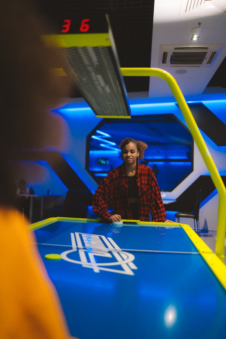 A Woman Playing Air Hockey