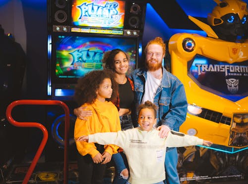 A Family Standing Near the Video Game Machines