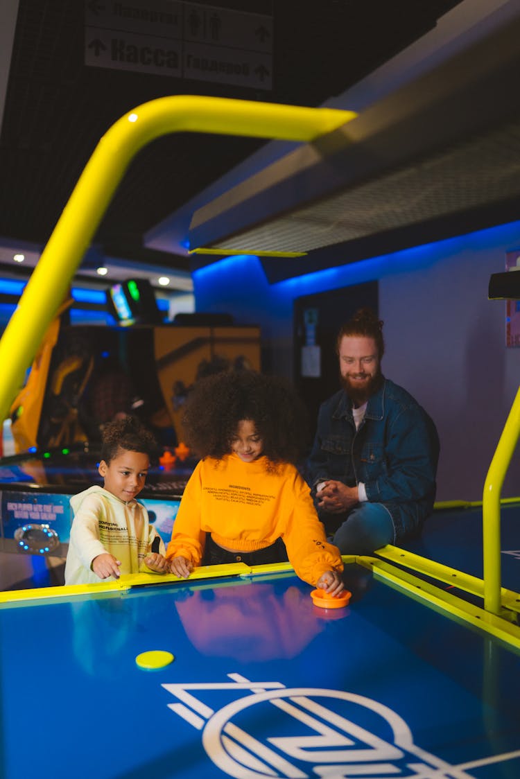 Two Kids Playing Air Hockey