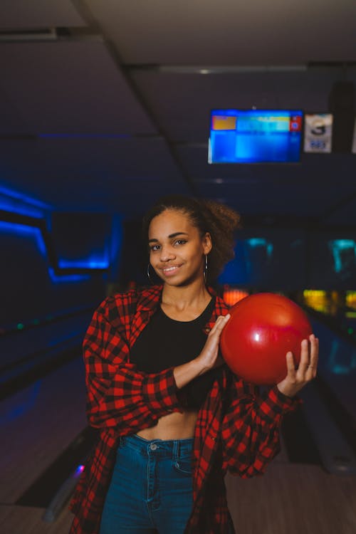 A Woman Holding a Red Bowling Ball