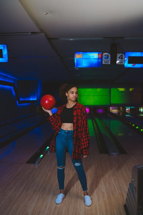 Free A Woman Holding a Red Bowling Ball Stock Photo