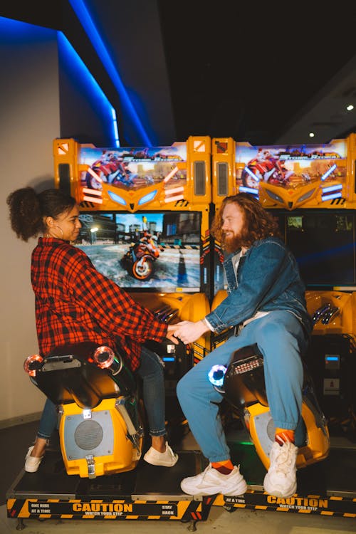 A Couple Holding Hands while Looking at Each Other