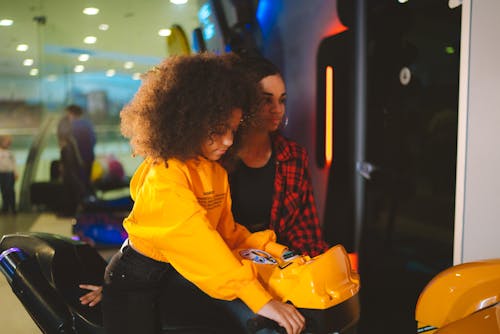 A Girl Playing an Arcade Game