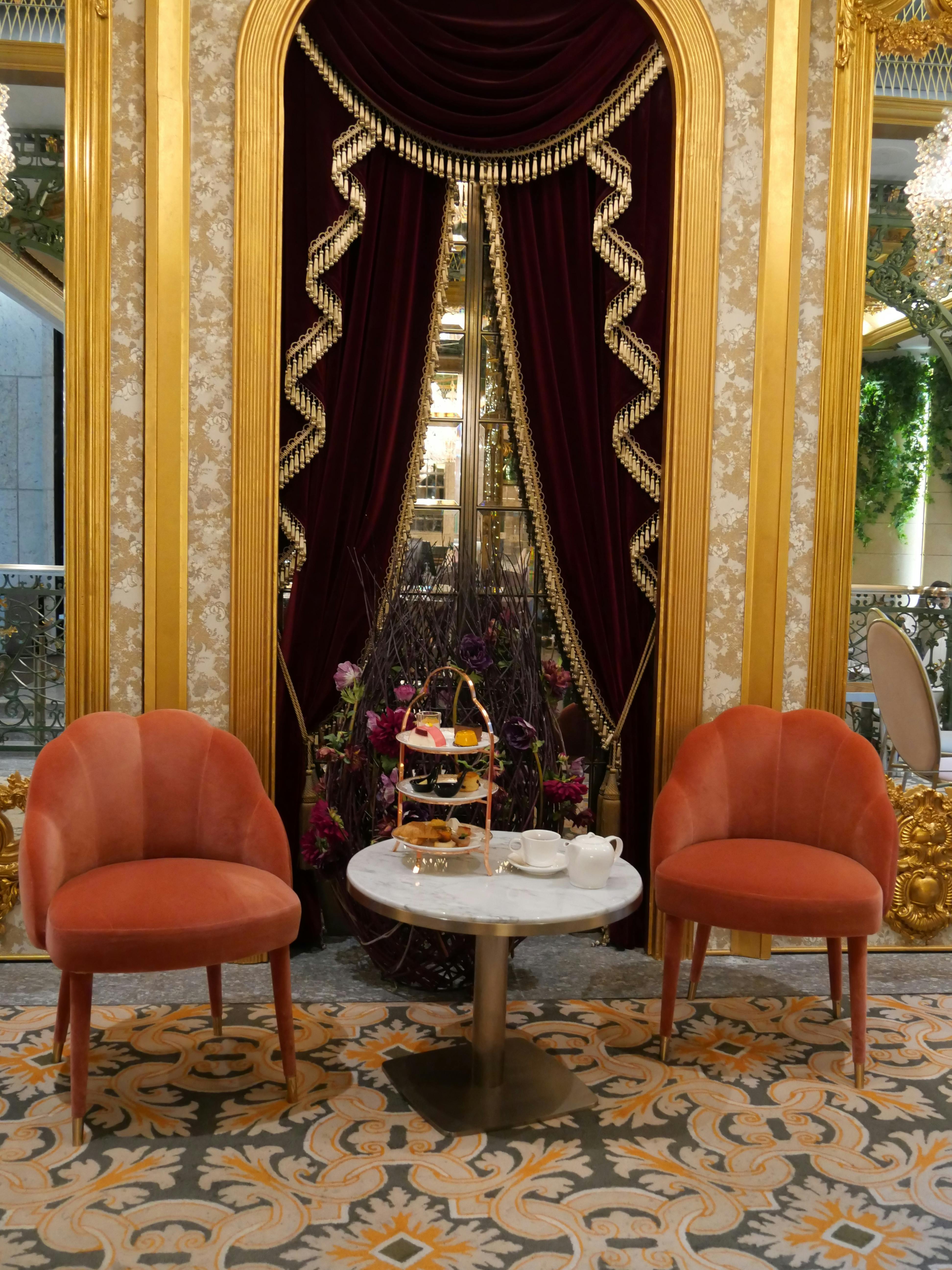 coffee table and chairs with antique curtains behind