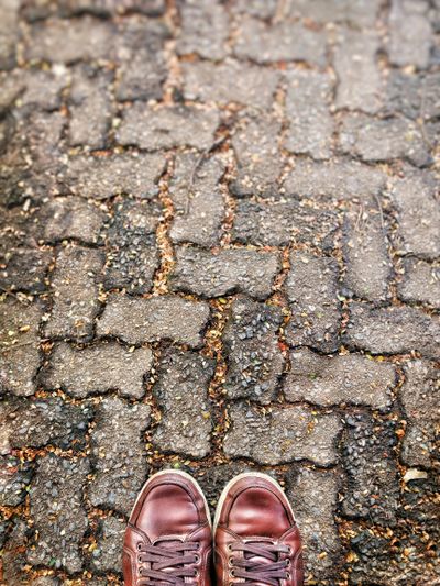 Brown leather shoes on a cobblestone street — photo by Marcelo Amantino on Pexels