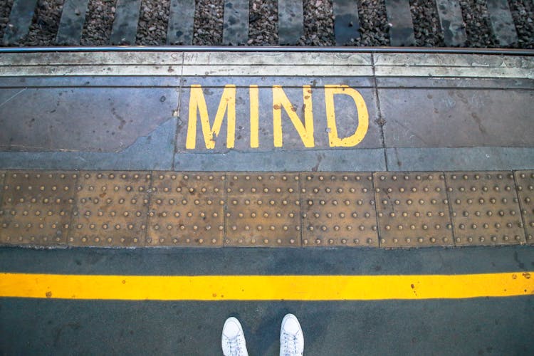 Person Standing Behind A Yellow Line