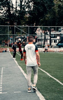 A soccer player concentrates during practice on a lush green field in Manizales, Colombia.