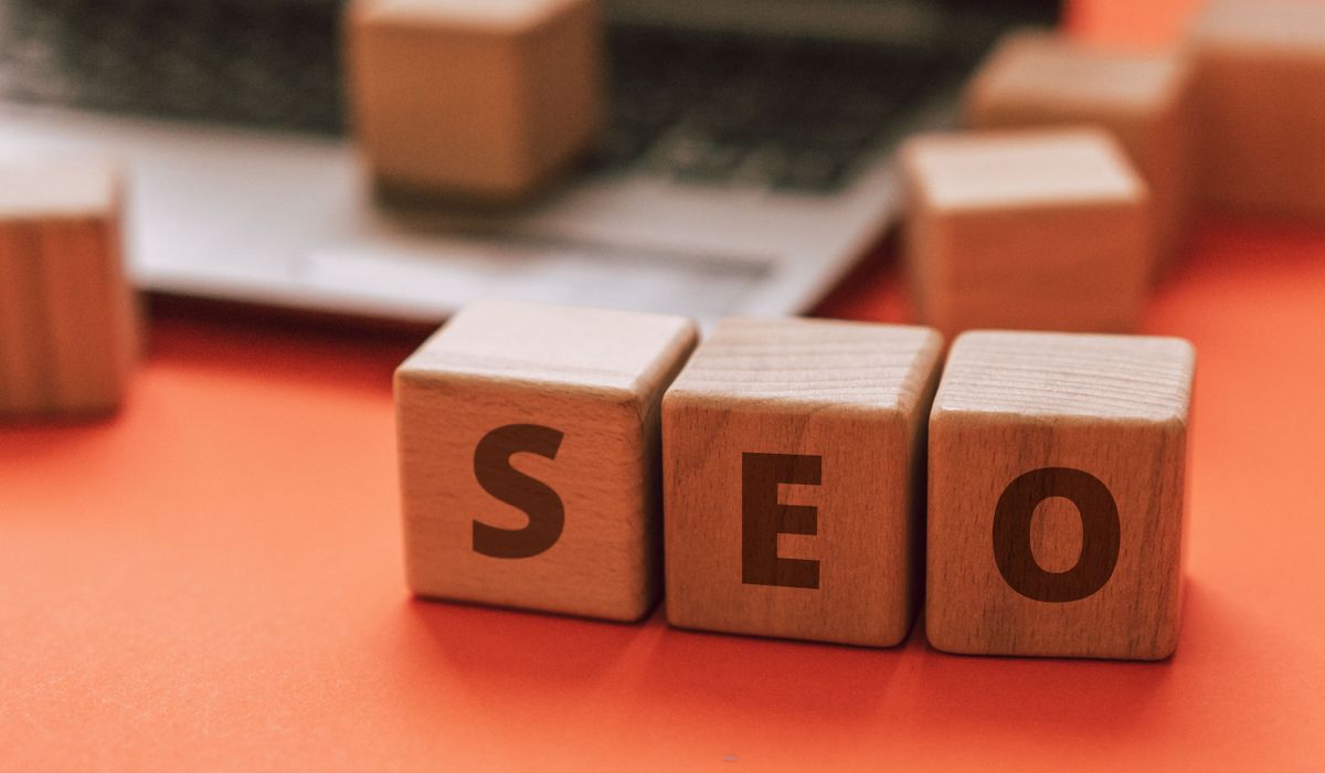 Wooden blocks spelling SEO on a laptop keyboard