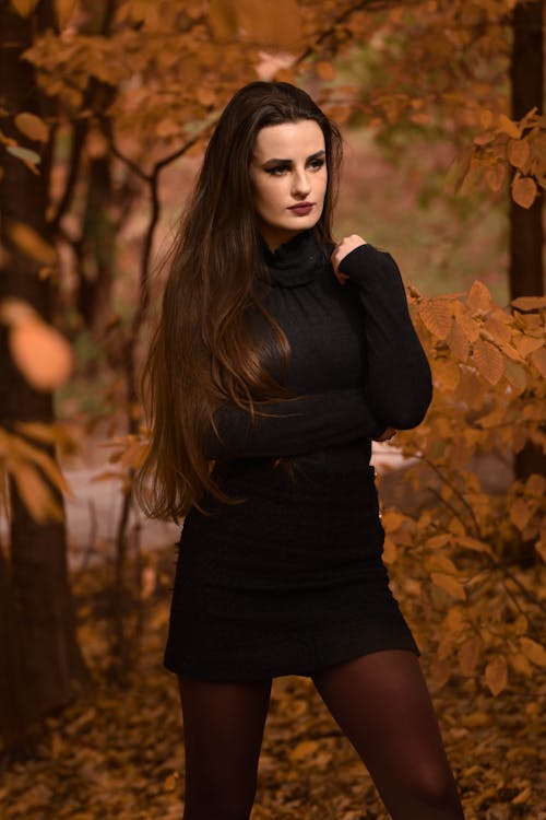 A Woman in Black Long Sleeve Dress with Long Hair