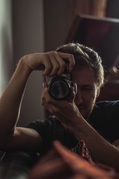 Photographer capturing a moment indoors with a camera.
