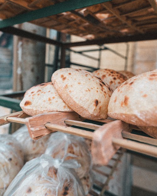 A Stock of Round Bread on a Wooden Rack