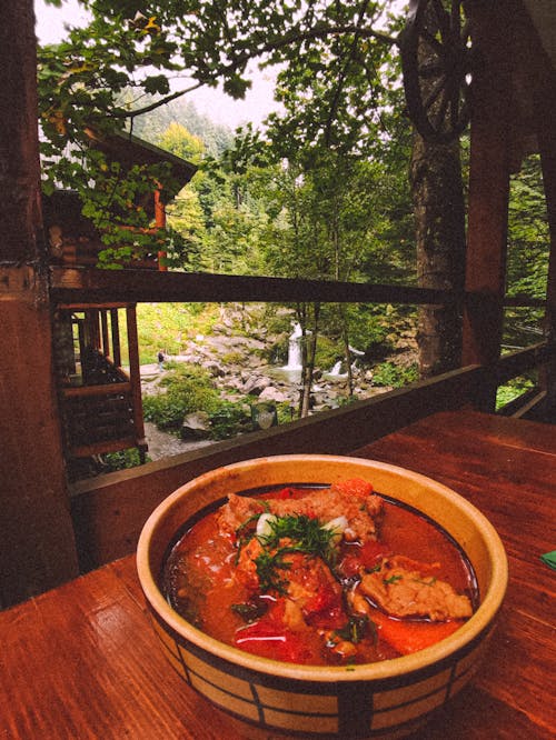 A Bowl of Chili Soup on a Wooden Table