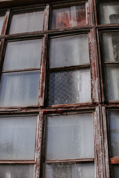 Free Close-up of an old window with peeling paint, capturing a rustic and vintage aesthetic. Stock Photo