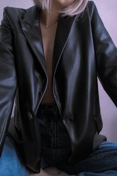 Stylish woman in leather blazer and jeans exudes modern fashion.