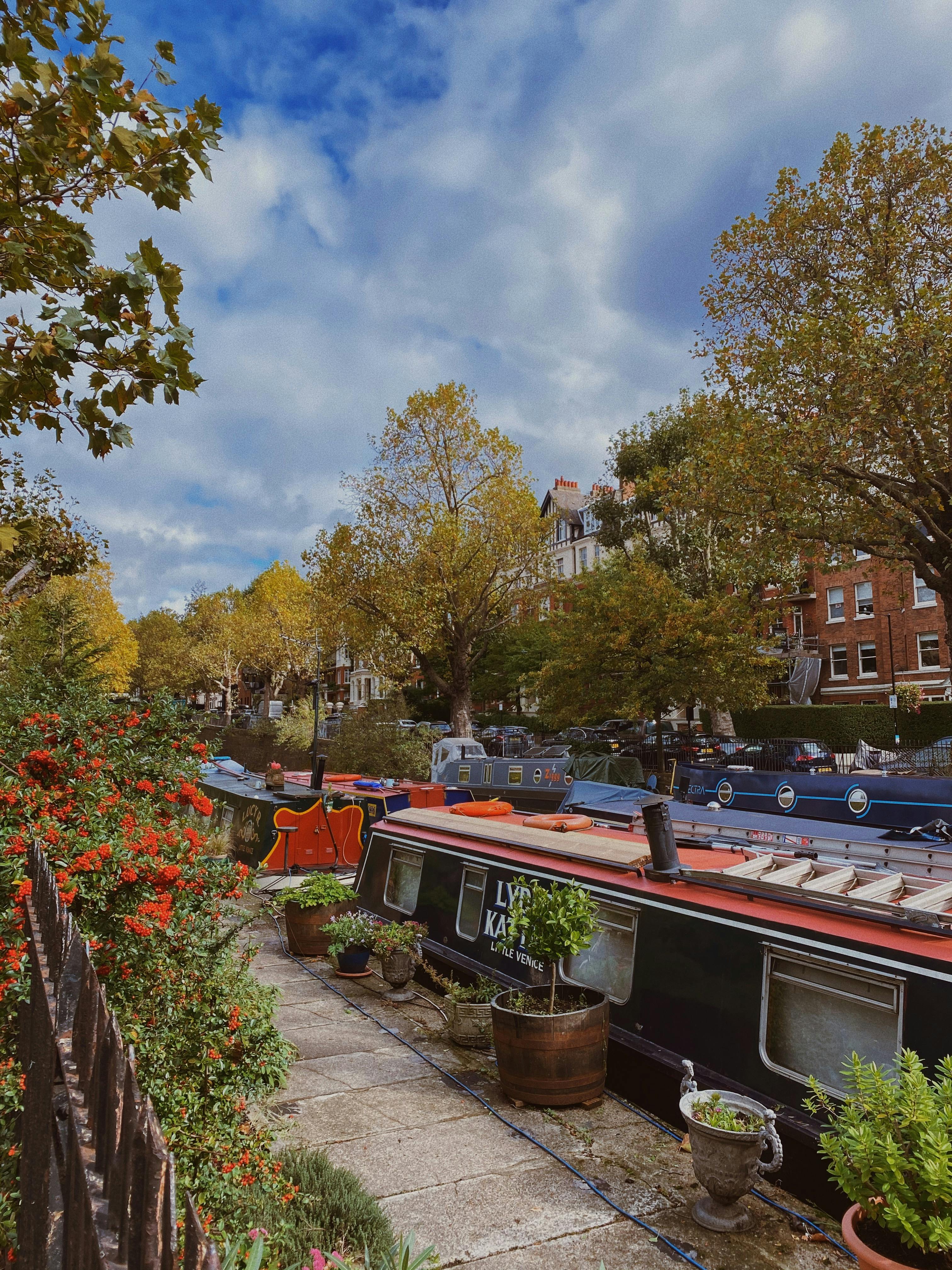 Free Narrowboats on Canal on City Street Stock Photo