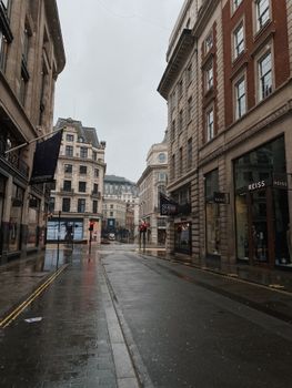 A rainy day in London's shopping district with classic architecture and empty streets.