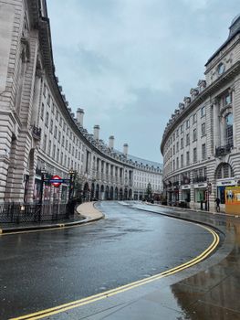 Discover the historic beauty of Regent Street, London, captured on a serene rainy day, showcasing its iconic curved architecture.