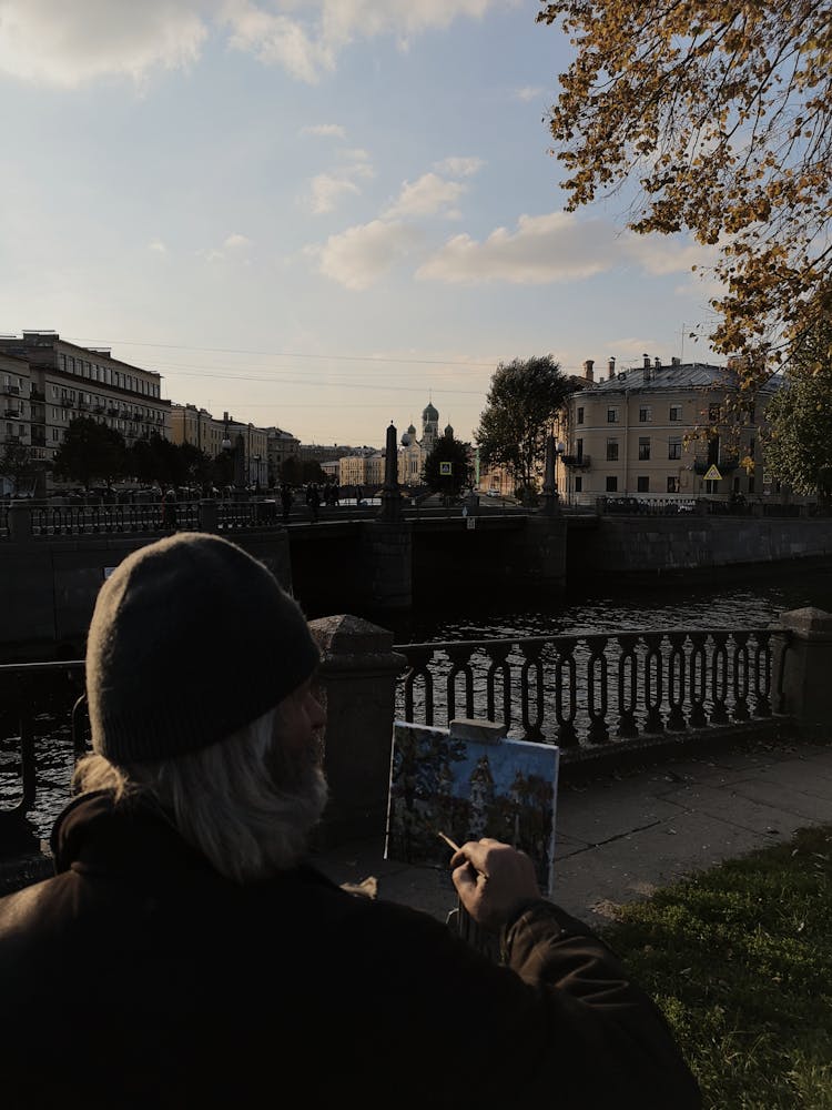 Artist Drawing Sitting Near Bridge In City