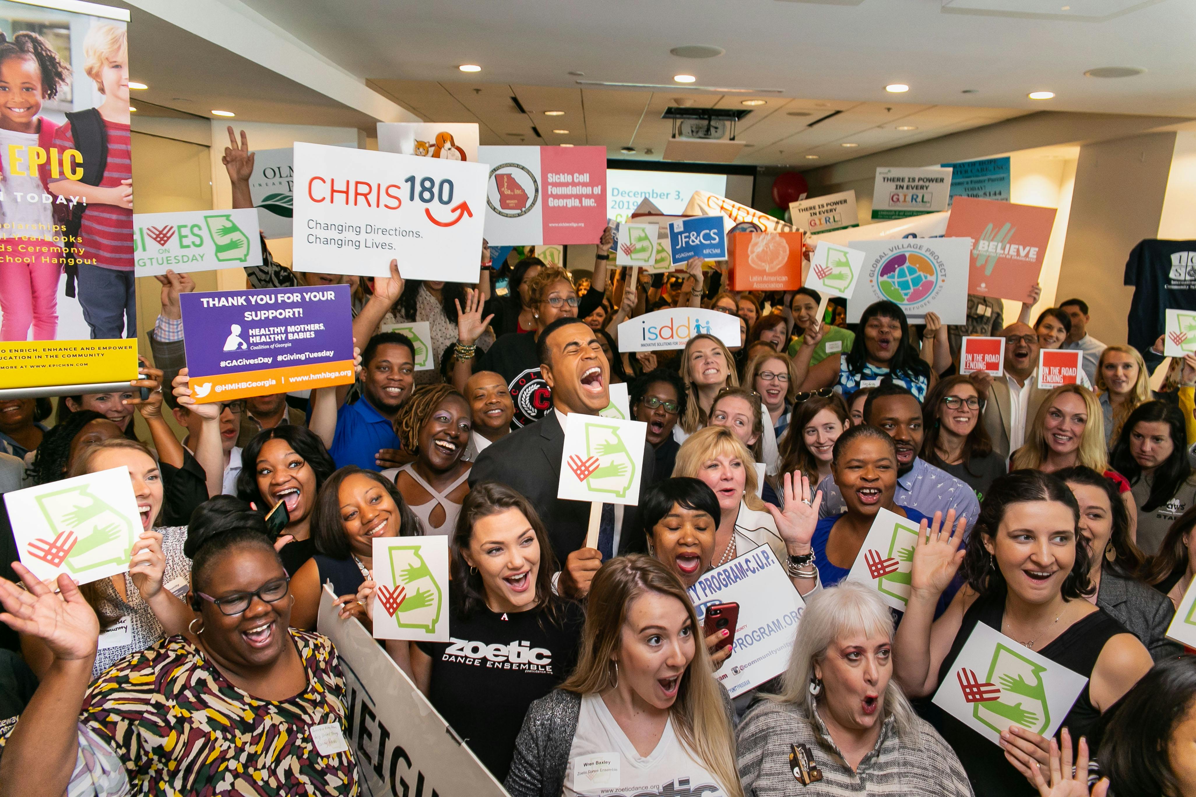 A large group of people cheering at charity event