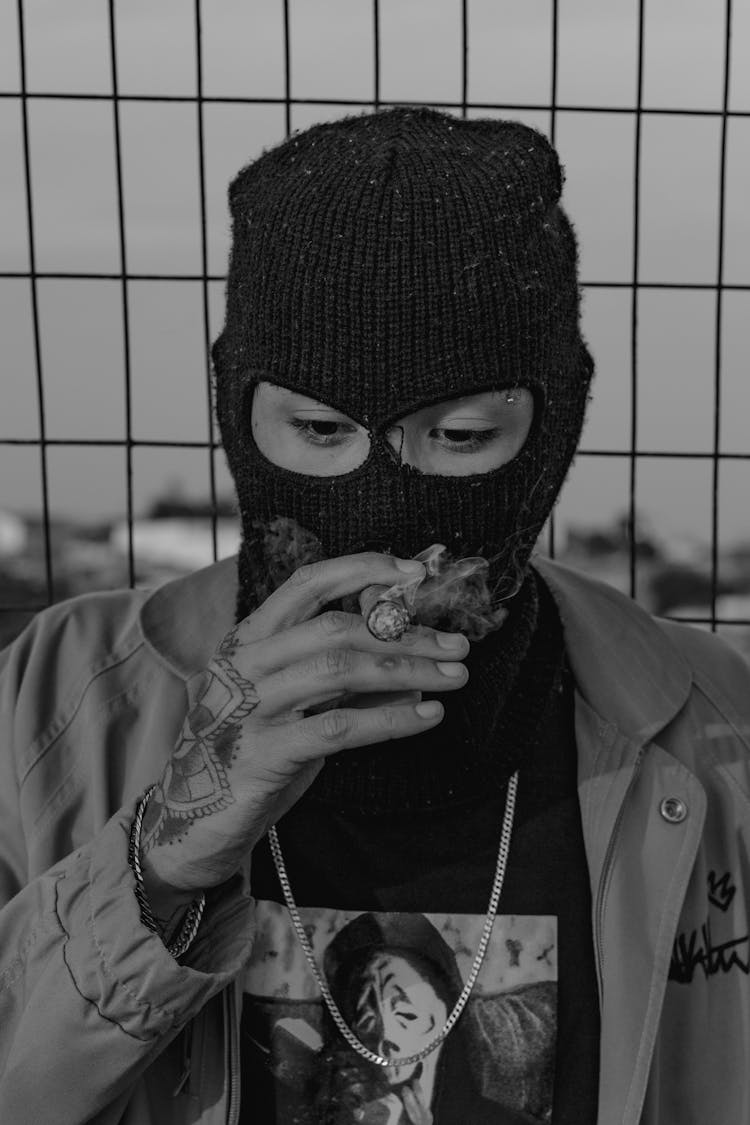 Person Smoking While Wearing Balaclava Mask 