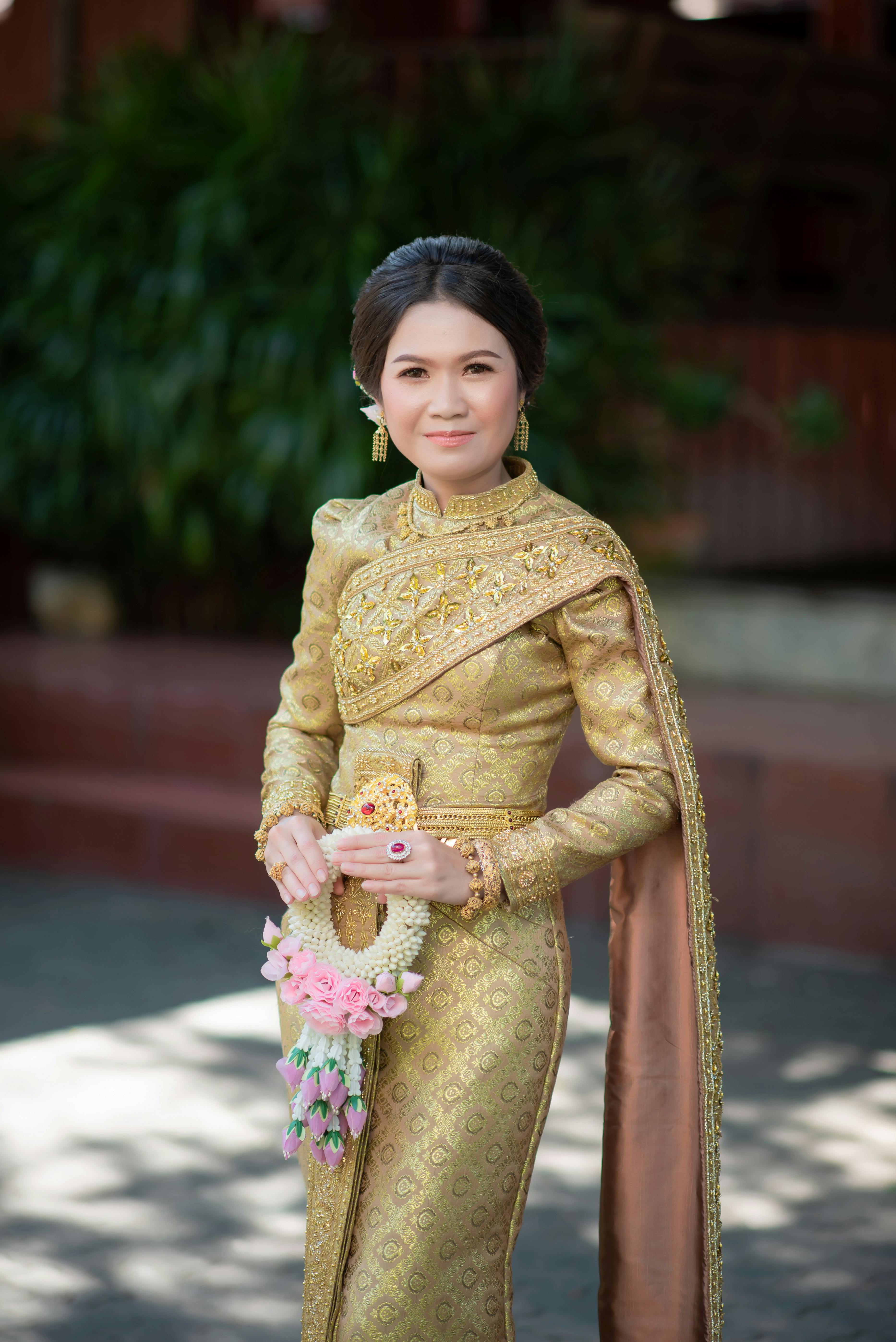 A Woman in Gold Traditional Dress  Free Stock Photo