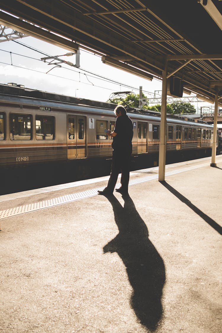 A Man Standing On A Train Platform