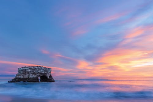 Rock Formation in Water During Sunset