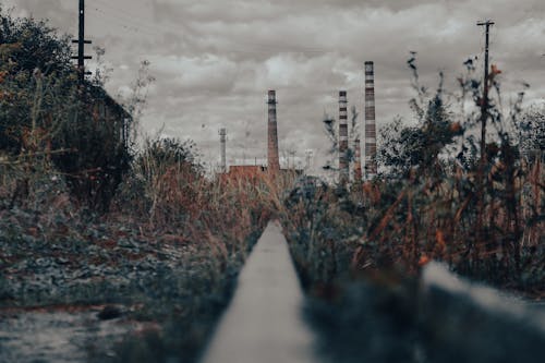 Industrial Chimneys Near Grass Field