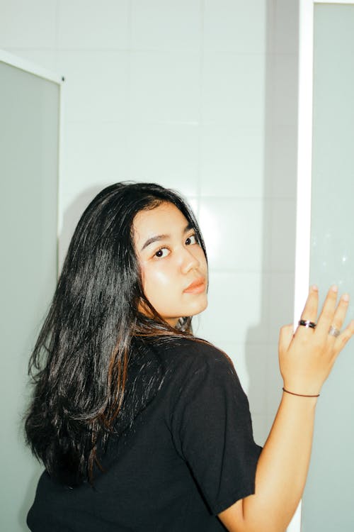 A Woman in a Black Shirt Looking Over Her Shoulder 