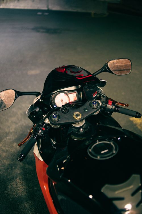 Free Detailed view of motorcycle handlebars and dashboard in an urban night setting. Stock Photo
